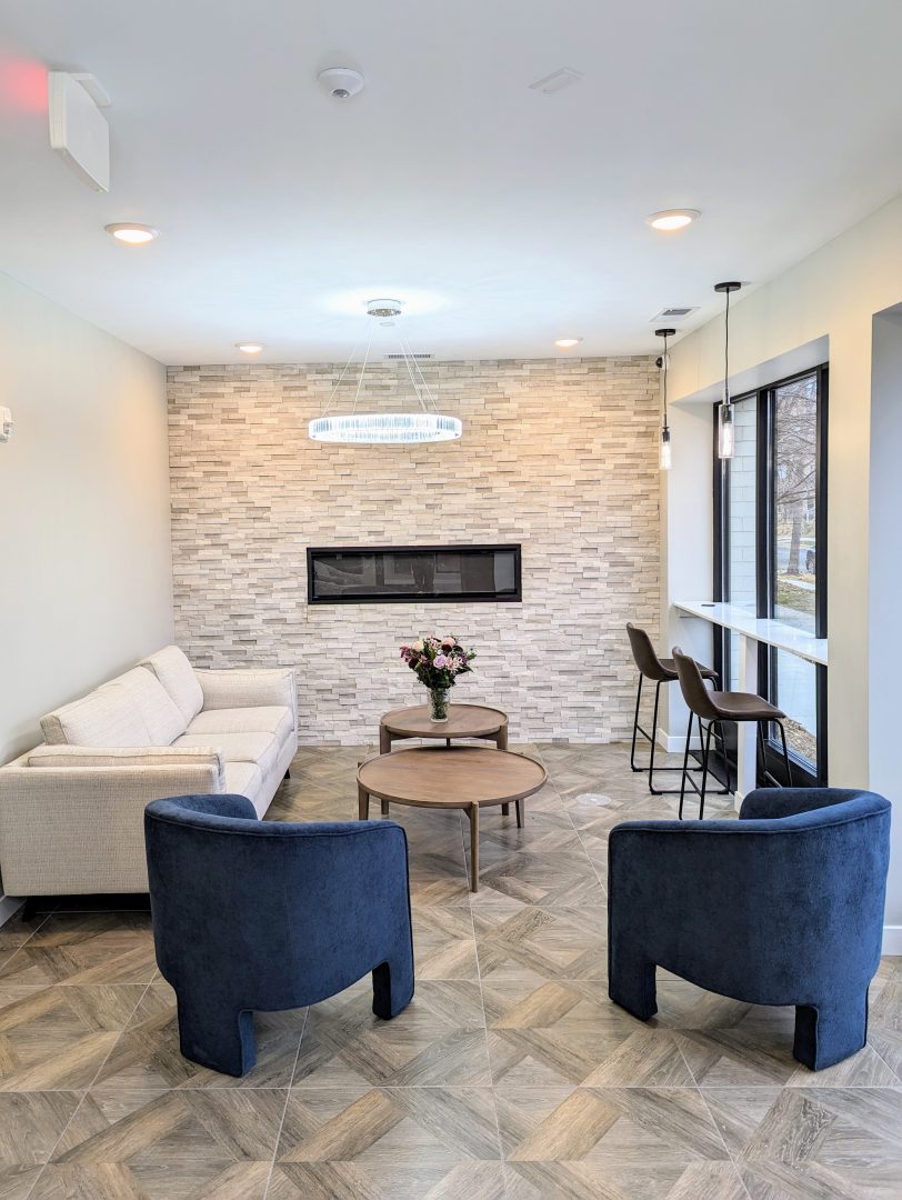 the lobby of a modern apartment building at Fuller Park Flats with a fireplace and seating